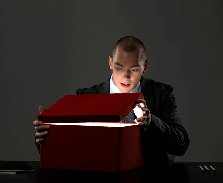 low doc home loan broker looking inside box with shining light